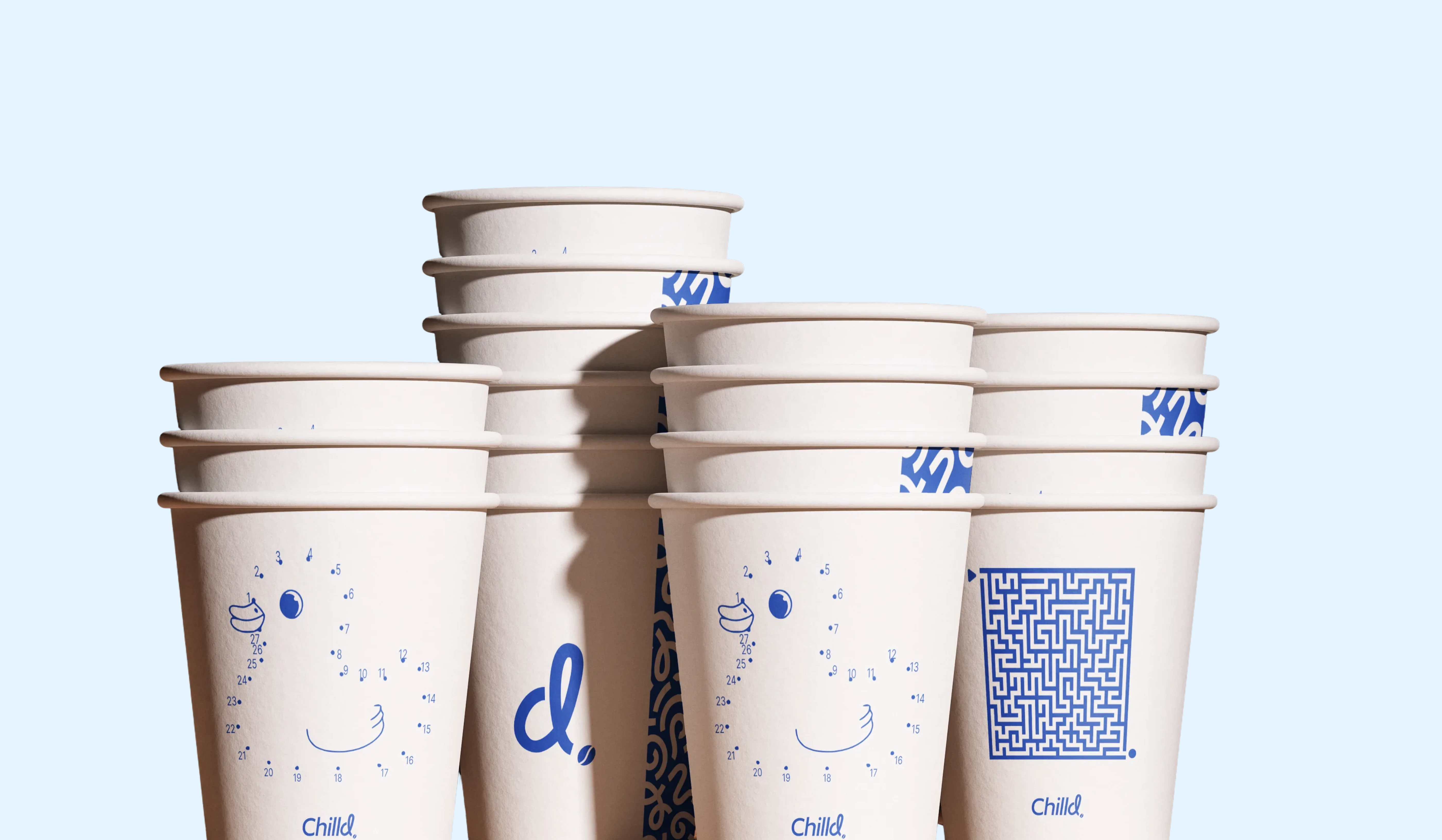 Stacked takeaway paper cups with interactive connect-the-dots and maze graphics.