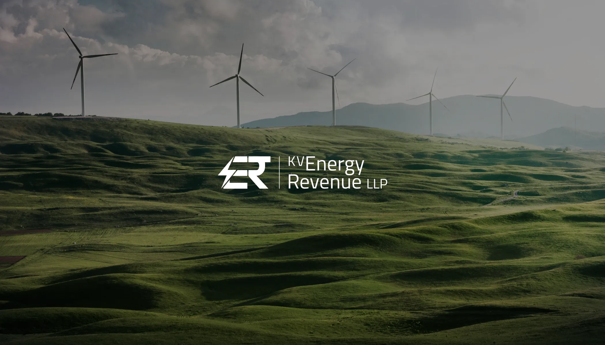 White KV Energy Revenue LLP logo overlaid on a scenic landscape featuring wind turbines on green hills under a cloudy sky.