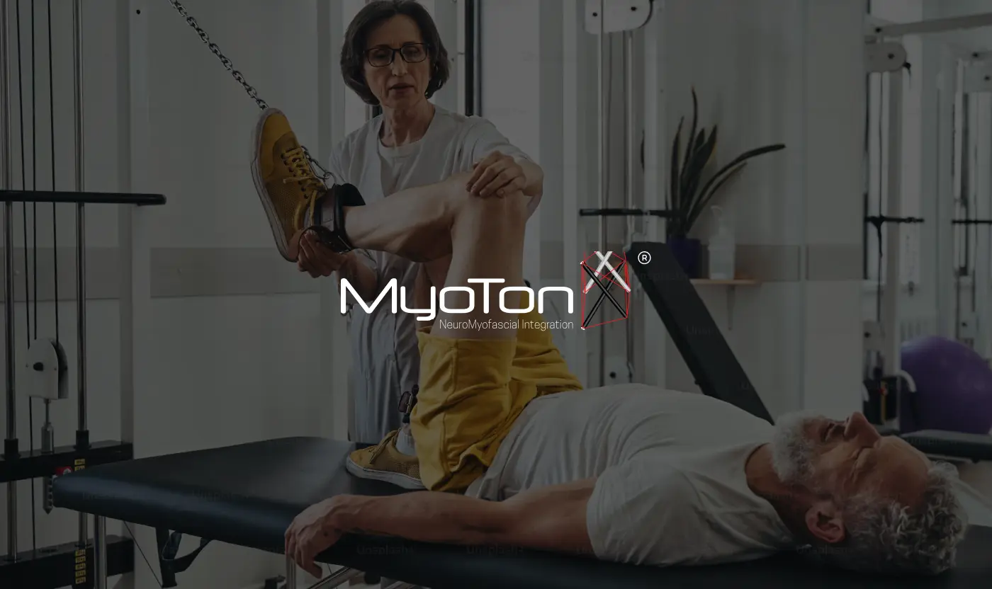 White Myotonx NeuroMyofascial Integration logo with its red 'X' icon overlaid on a photograph of a female therapist stretching an older male patient's leg in a clinic.